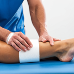 Sports Physiotherapy Clinic**

"A sports physiotherapist demonstrating proper taping technique on an athlete's ankle, fully clothed, in a bright and modern physiotherapy clinic. Exercise equipment and anatomical charts are visible in the background. Focus on correct form and educational setting. Safe for work, appropriate content, professional, modest clothing, perfect anatomy, natural proportions, well-formed hands, proper finger count, natural body proportions, family-friendly."

**